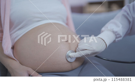 A portrait of happy Asian pregnant woman checkup with a doctor in bedroom at home. Having a baby. Family people lifestyle. Mom love. A portrait of happy Asian pregnant woman checkup with a doctor in bedroom at home. Having a baby. Family people lifestyle. Mom love. 115488381