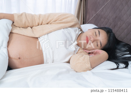 A Portrait of happy Asian pregnant woman in bedroom at home. Having a baby. Family people lifestyle. Love. 115488411