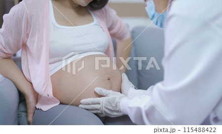A portrait of happy Asian pregnant woman checkup with a doctor in bedroom at home. Having a baby. Family people lifestyle. Mom love. A portrait of happy Asian pregnant woman checkup with a doctor in bedroom at home. Having a baby. Family people lifestyle. Mom love. 115488422