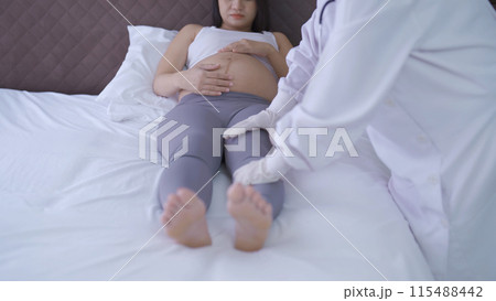 A portrait of happy Asian pregnant woman checkup with a doctor in bedroom at home. Having a baby. Family people lifestyle. Mom love. 115488442