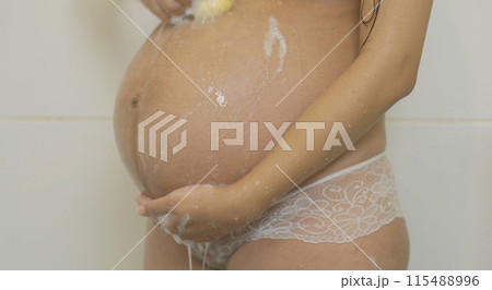 A portrait of happy Asian pregnant woman taking a shower. Having a baby. Family people lifestyle. Mom love. 115488996