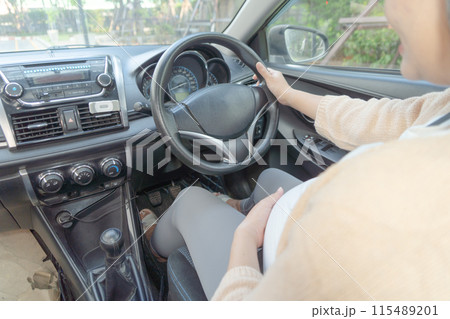 A Portrait of happy Asian pregnant woman driving a car vehicle. Having a baby. Family people lifestyle. Mom love. Journey. A Portrait of happy Asian pregnant woman driving a car vehicle. Having a baby. Family people lifestyle. Mom love. Journey. 115489201