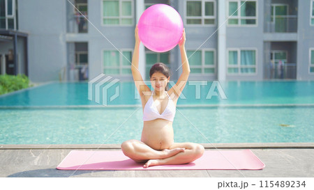 A portrait of happy Asian pregnant woman by the swimming pool. People lifestyle in travel holiday vacation concept. Relaxation. Having a baby. Family people lifestyle. Mom love. 115489234