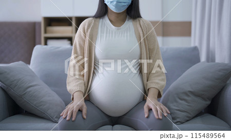 Depressed lonely Asian pregnant divorce woman with a mask for protecting covid-19 in bedroom at home. Having a baby. Family people lifestyle. Mom. quarantine Depressed lonely Asian pregnant divorce woman with a mask for protecting covid-19 in bedroom at home. Having a baby. Family people lifestyle. Mom. quarantine 115489564