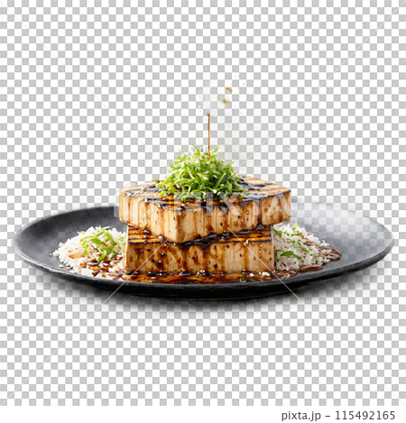 Marinated tofu steaks juicy and flavorful sizzling and flipping with a misty spray of teriyaki 115492165