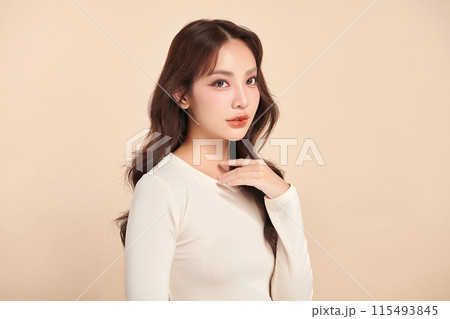 Beautiful young asian woman with clean fresh skin on beige background, Face care, Facial treatment, Cosmetology, beauty and spa, Asian women portrait. 115493845