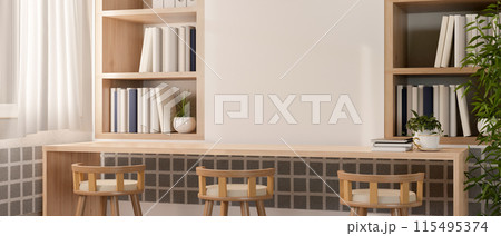 A long wooden table with stools against the wall with wall shelf in a minimalist Scandinavian room. 115495374
