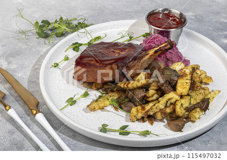 Meat on the bone with fried potatoes and mushrooms. Hot lunch. 115497032