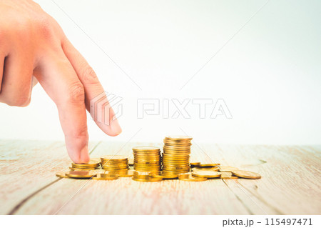 business and finance investment and saving activity with gold coin arrange on white isolated with finger acting background 115497471