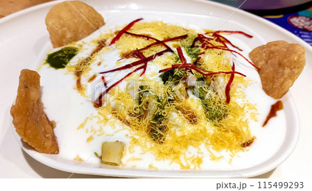 Famous Indian Dahi vada or dahi bhalla chaat served with papdi and sev and chatni. Famous Indian Dahi vada or dahi bhalla chaat served with papdi and sev and chatni. 115499293
