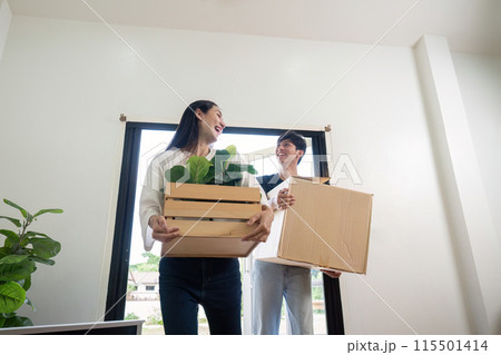 Happy Couple Moving into New Home with Boxes and Plants, Celebrating New Beginnings and Fresh Start in Modern House, Bright and Cheerful Atmosphere, Excited for Future Together Happy Couple Moving into New Home with Boxes and Plants, Celebrating New Beginnings and Fresh Start in Modern House, Bright and Cheerful Atmosphere, Excited for Future Together 115501414