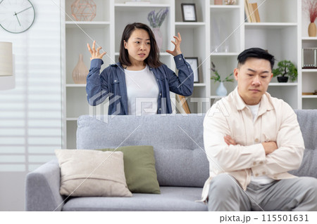 Young couple having an argument in their living room, showcasing stress and relationship issues. Young couple having an argument in their living room, showcasing stress and relationship issues. 115501631