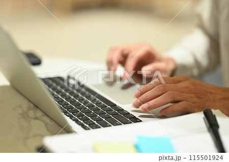 Close up of unrecognizable businessman typing at laptop keyboard remote work, browsing internet in office 115501924