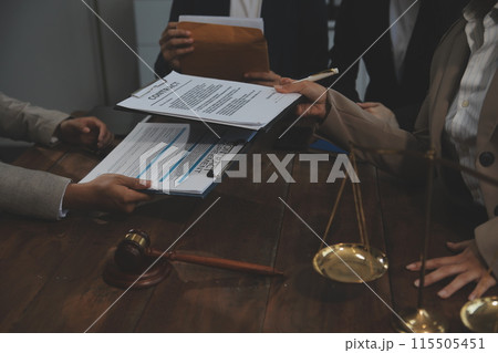 Judge gavel with Justice lawyers having team meeting at law firm background. Concepts of Law and Legal services. Judge gavel with Justice lawyers having team meeting at law firm background. Concepts of Law and Legal services. 115505451