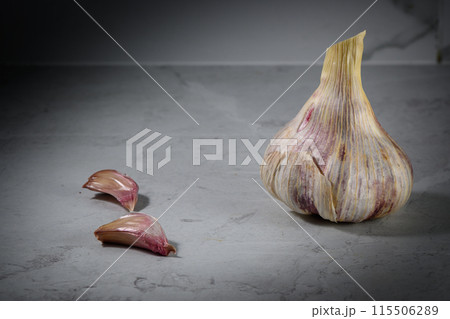 Still life photo of organic whole garlic on a light stone background 1 Still life photo of organic whole garlic on a light stone background 1 115506289