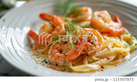Pasta with shrimp in creamy sauce and herbs close-up. 115507973