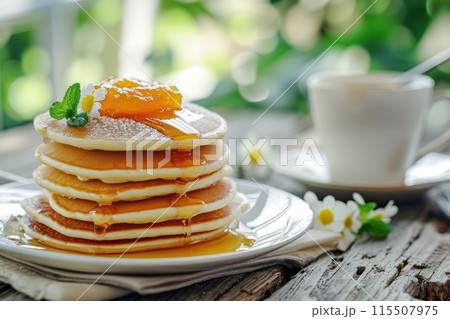 Appetizing pancakes with apricot or peach jam on a wooden table outdoor. Delicious breakfast for tea. Appetizing pancakes with apricot or peach jam on a wooden table outdoor. Delicious breakfast for tea. 115507975
