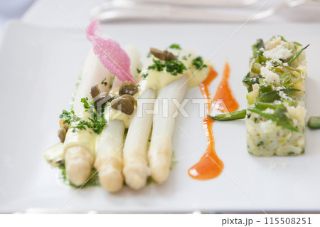 Indulgent Gourmet White Asparagus Dish with Elegant Garnishes and Sauces, perfect for fine dining Indulgent Gourmet White Asparagus Dish with Elegant Garnishes and Sauces, perfect for fine dining 115508251