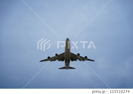 Airplane is flying in the sky with the landing gear down 115510274