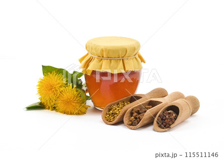 A jar of honey with fabric lid, pollen granules, beebread, and dandelion flowers A jar of honey with fabric lid, pollen granules, beebread, and dandelion flowers 115511146