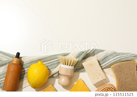 Natural cleaning products, bottle and towel on light background, space for text 115511525