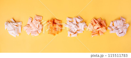 Bunches of snus bags with different flavors and different colors on a yellow background 115511783