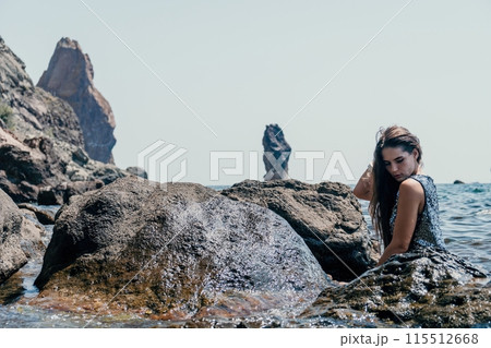 Woman summer travel sea. Happy tourist enjoy taking picture outdoors for memories. Woman traveler posing on the beach at sea surrounded by volcanic mountains, sharing travel adventure journey Woman summer travel sea. Happy tourist enjoy taking picture outdoors for memories. Woman traveler posing on the beach at sea surrounded by volcanic mountains, sharing travel adventure journey 115512668