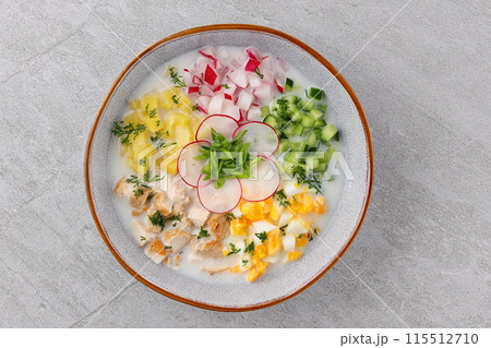 Okroshka smoked chicken breast - Russian cold soup with vegetables on white wooden background. Selective focus 115512710