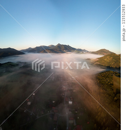 Stunning mountain valley is covered with fog with green alpine meadows. Location place Carpathian mountains,Slovakia Europe. Aerial photography. Perfect photo wallpaper. Discover the beauty of earth. 115512933