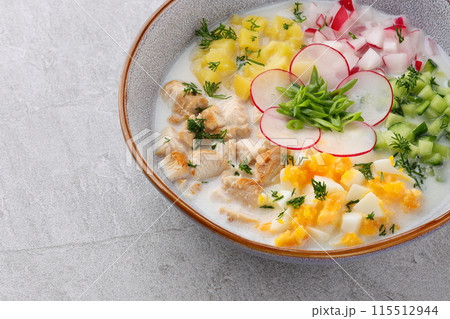 Okroshka smoked chicken breast - Russian cold soup with vegetables on white wooden background. Selective focus Okroshka smoked chicken breast - Russian cold soup with vegetables on white wooden background. Selective focus 115512944