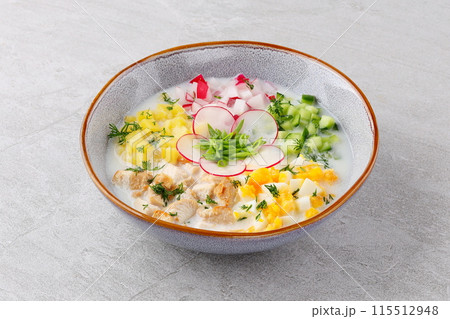 Okroshka smoked chicken breast - Russian cold soup with vegetables on white wooden background. Selective focus Okroshka smoked chicken breast - Russian cold soup with vegetables on white wooden background. Selective focus 115512948