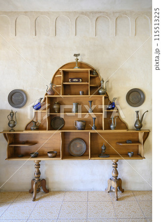 Wooden shelf with antique Arabic kitchen utensils in Fujairah, United Arab Emirates 115513225