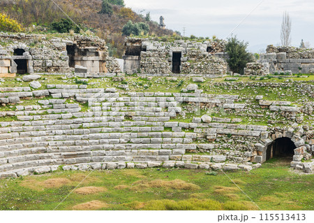 Ancient stone seats in amphitheater 115513413