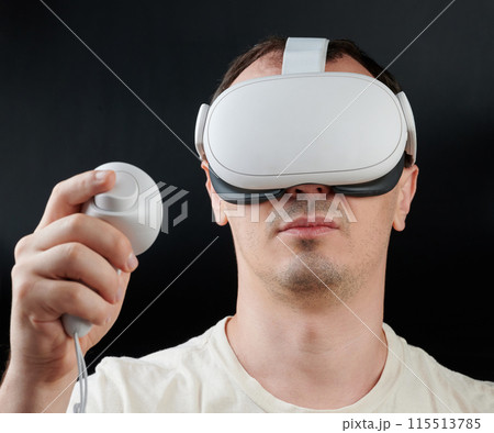 Portrait of man playing in Virtual reality Portrait of man playing in Virtual reality 115513785