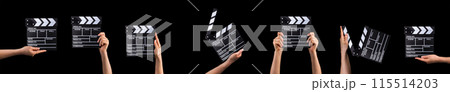 Human hand holding film clapper board isolated on black background. 115514203