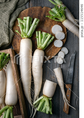 Whole and sliced white daikon radish roots 115514646