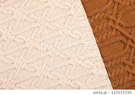Knitted brown and beige background. Large knitted fabric with a pattern. Close-up of a knitted blanket. 115515150