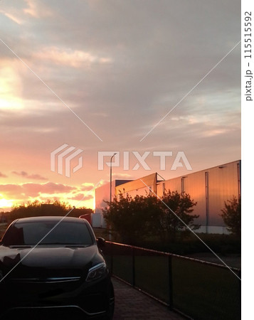 Beautiful sunset and polished car. In the foreground is a car against the backdrop of a red sunset. Beautiful sunset and polished car. In the foreground is a car against the backdrop of a red sunset. 115515592