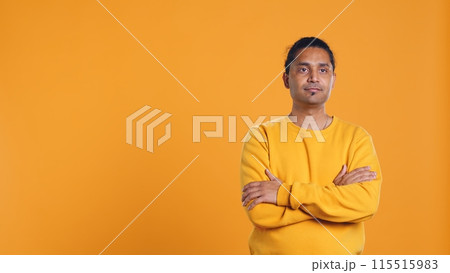 Portrait of cheerful friendly indian man smiling, looking pleased, isolated over yellow studio background. Happy expressive asian person grinning, feeling satisfied, camera B Portrait of cheerful friendly indian man smiling, looking pleased, isolated over yellow studio background. Happy expressive asian person grinning, feeling satisfied, camera B 115515983