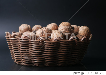 walnuts in a bowl on black background  115518179