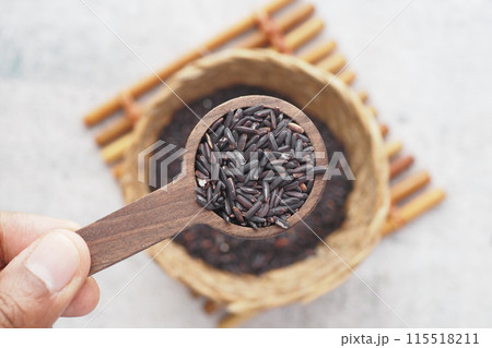Black Rice Grains in a wooden spoon  115518211