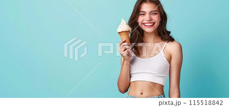 Smiling young woman in white tank top holding ice cream cone against blue background, representing summer fun and enjoyment. 115518842