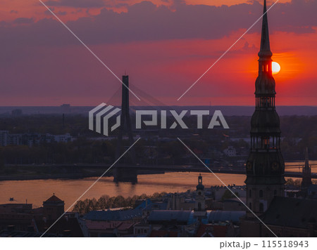 Magical aerial sunset over Riga old town, the capital of Latvia. Riga rooftop view panorama at sunset with urban architectures and Daugava River. 115518943