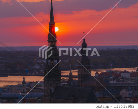 Magical aerial sunset over Riga old town, the capital of Latvia. Riga rooftop view panorama at sunset with urban architectures and Daugava River. 115518982