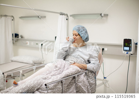 Young woman in hospital recovery room after surgery Young woman in hospital recovery room after surgery 115519365