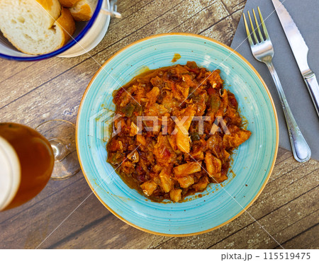 Cod stew with vegetables peppers, tomatoes, garlic and onions close-up in bowl on the table Cod stew with vegetables peppers, tomatoes, garlic and onions close-up in bowl on the table 115519475