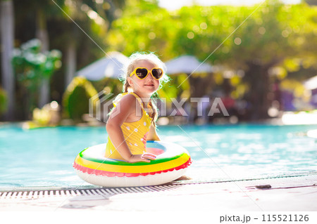 Child in swimming pool. Kids swim. Water play. 115521126