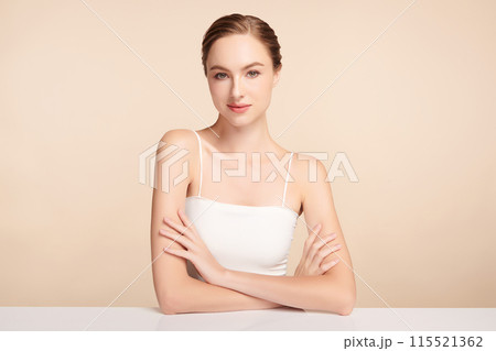 Beautiful young woman with clean fresh skin on beige background, Face care, Facial treatment, Cosmetology, beauty and spa, women portrait. Beautiful young woman with clean fresh skin on beige background, Face care, Facial treatment, Cosmetology, beauty and spa, women portrait. 115521362