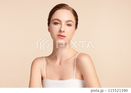 Beautiful young woman with clean fresh skin on beige background, Face care, Facial treatment, Cosmetology, beauty and spa, women portrait. Beautiful young woman with clean fresh skin on beige background, Face care, Facial treatment, Cosmetology, beauty and spa, women portrait. 115521390
