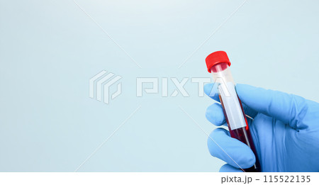 Blood sample in a test tube that a doctor is holding , horizontal banner with copy space 115522135